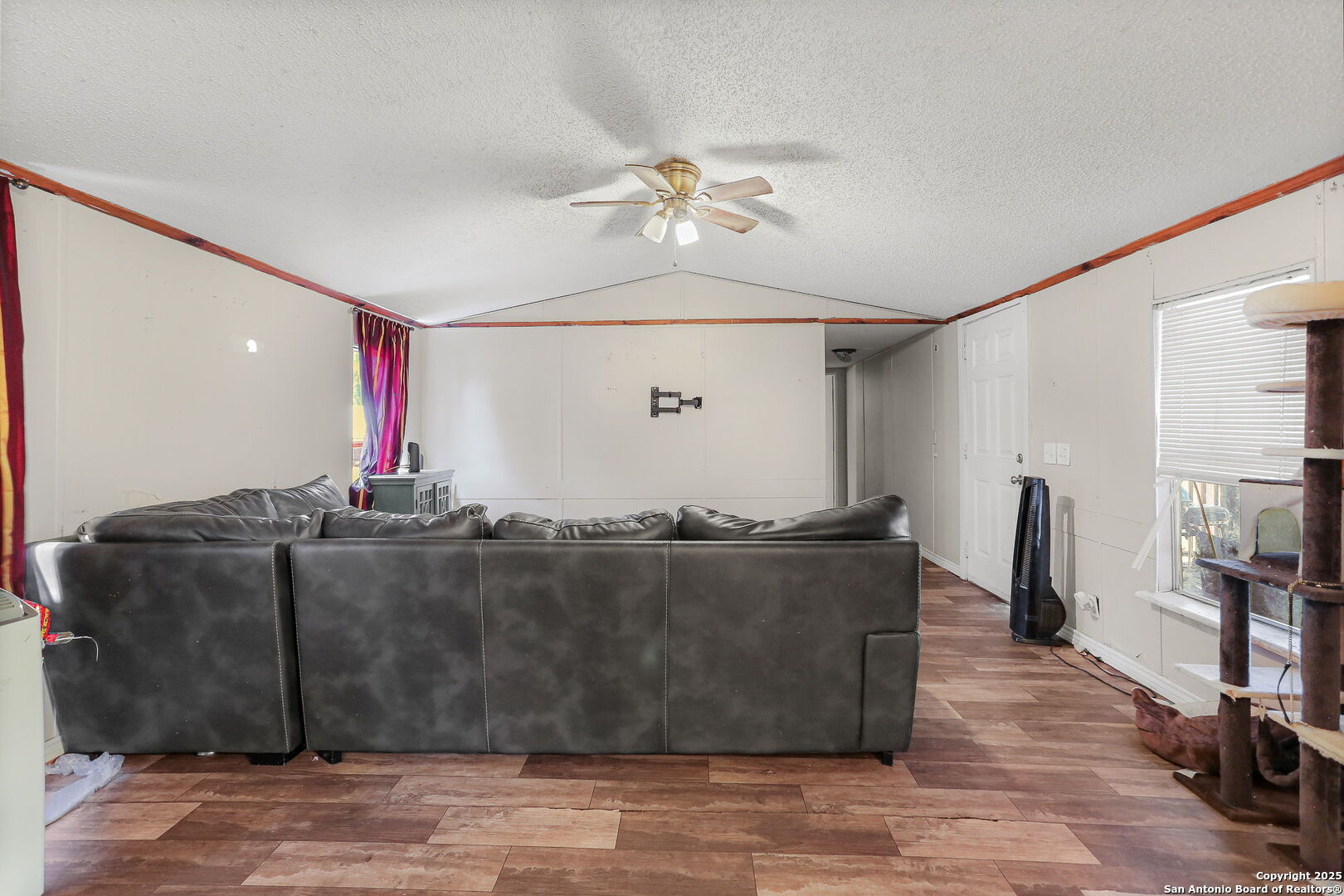 12925 Luckey Road Atascosa, TX 78002 - Photo 27 of 50 a living room with hard wood flooring and a ceiling fan