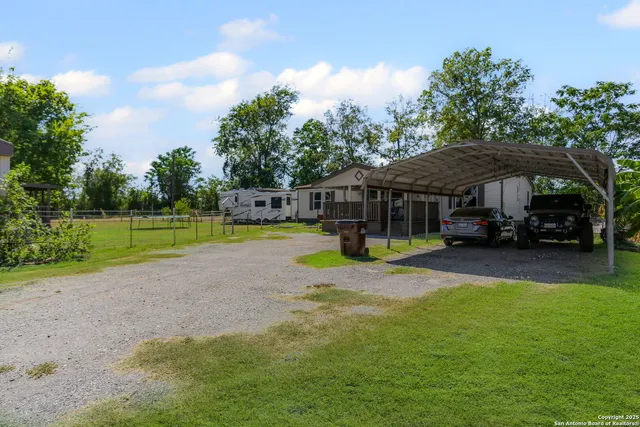 a view of a house with swimming pool and sitting area