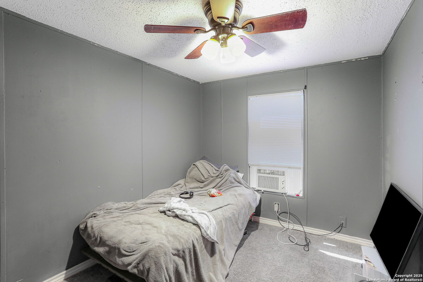 12925 Luckey Road Atascosa, TX 78002 - Photo 38 of 50 a bedroom with a bed and a chandelier