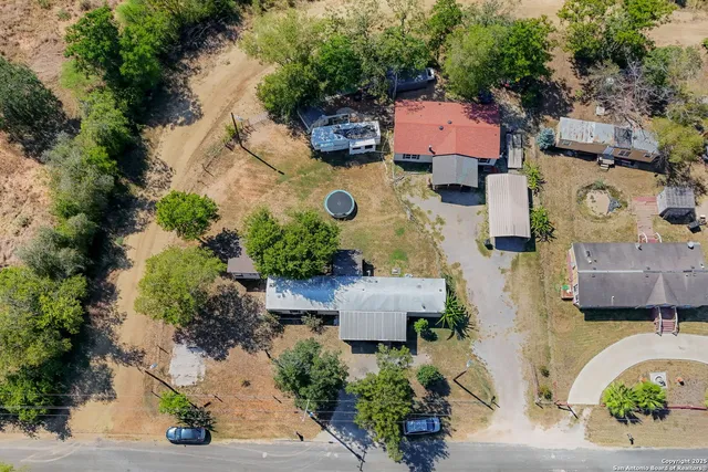 an aerial view of multiple houses with yard