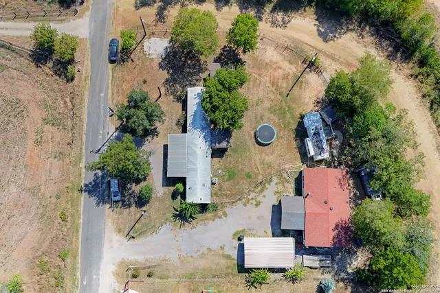 an aerial view of a house with outdoor space
