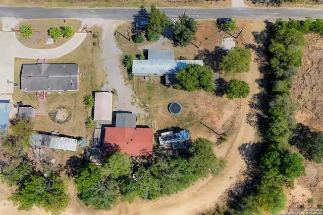 an aerial view of a house with a swimming pool