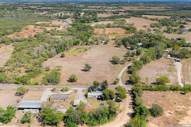 an aerial view of residential houses with outdoor space