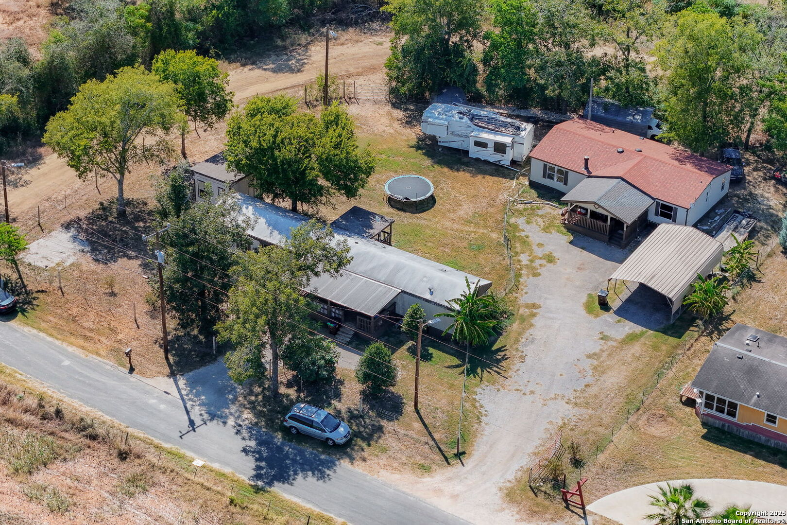 12925 Luckey Road Atascosa, TX 78002 - Photo 45 of 50 an aerial view of a house with garden space and lake view