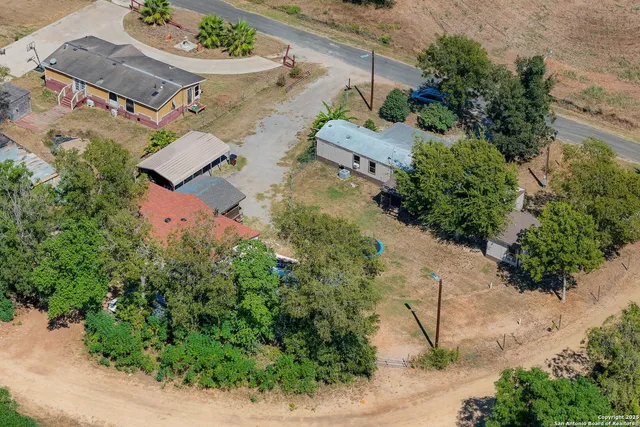 an aerial view of a house with a yard