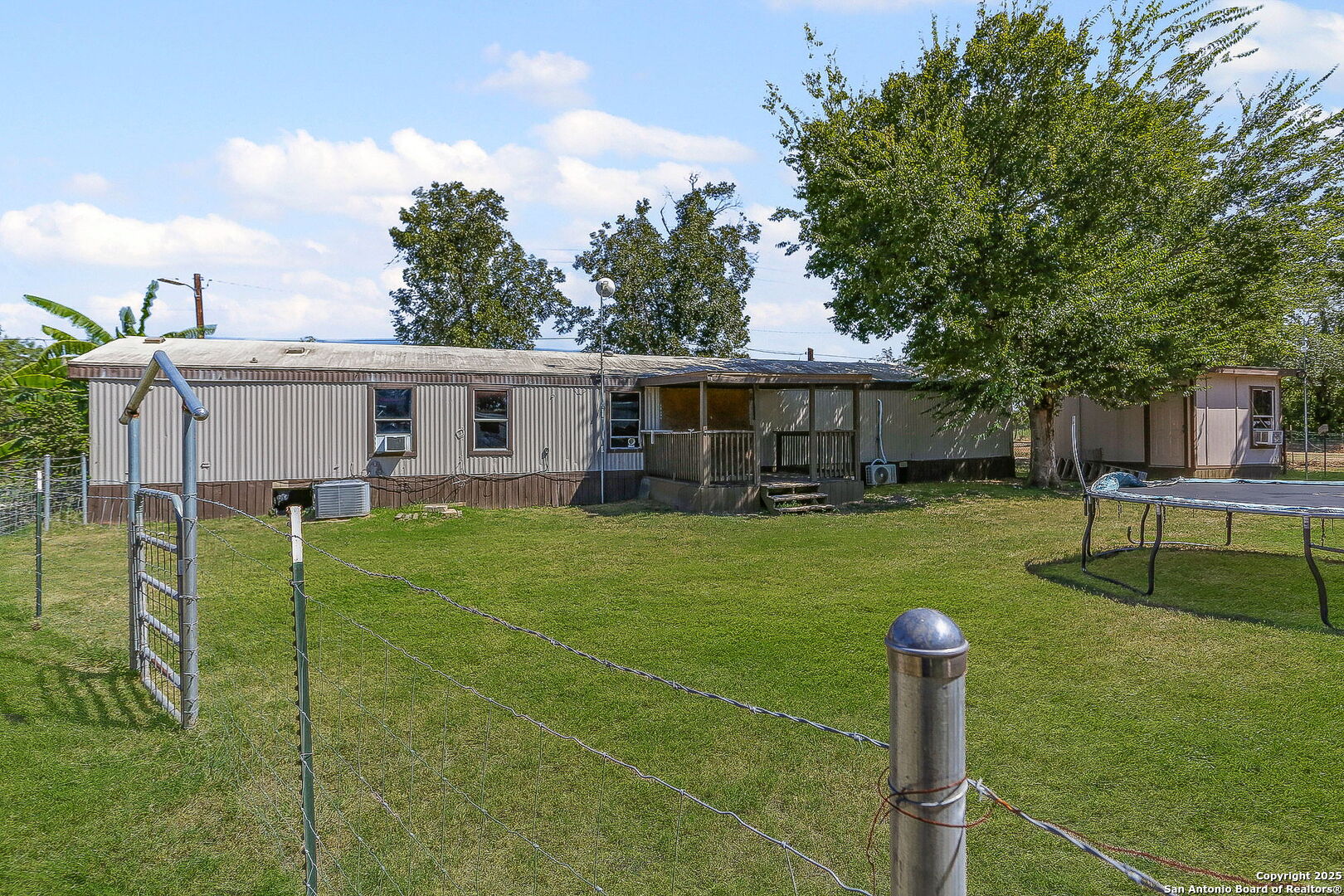 12925 Luckey Road Atascosa, TX 78002 - Photo 5 of 50 a front view of a house with a yard table and chairs