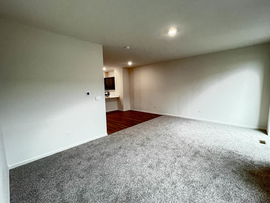392 Summit Circle Lombard, IL 60148 - Photo 9 of 61 an empty room with wooden floor and windows