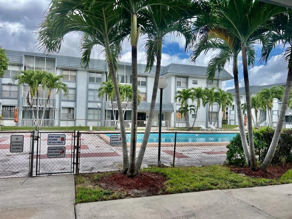 6705 Northwest 169th Street, Unit C205 Hialeah, FL 33015 - Photo 1 of 13 a view of multiple houses with a patio