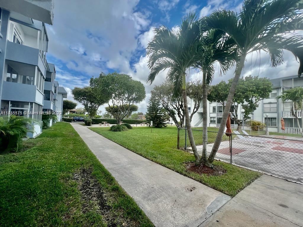 6705 Northwest 169th Street, Unit C205 Hialeah, FL 33015 - Photo 12 of 13 a view of a park with palm trees