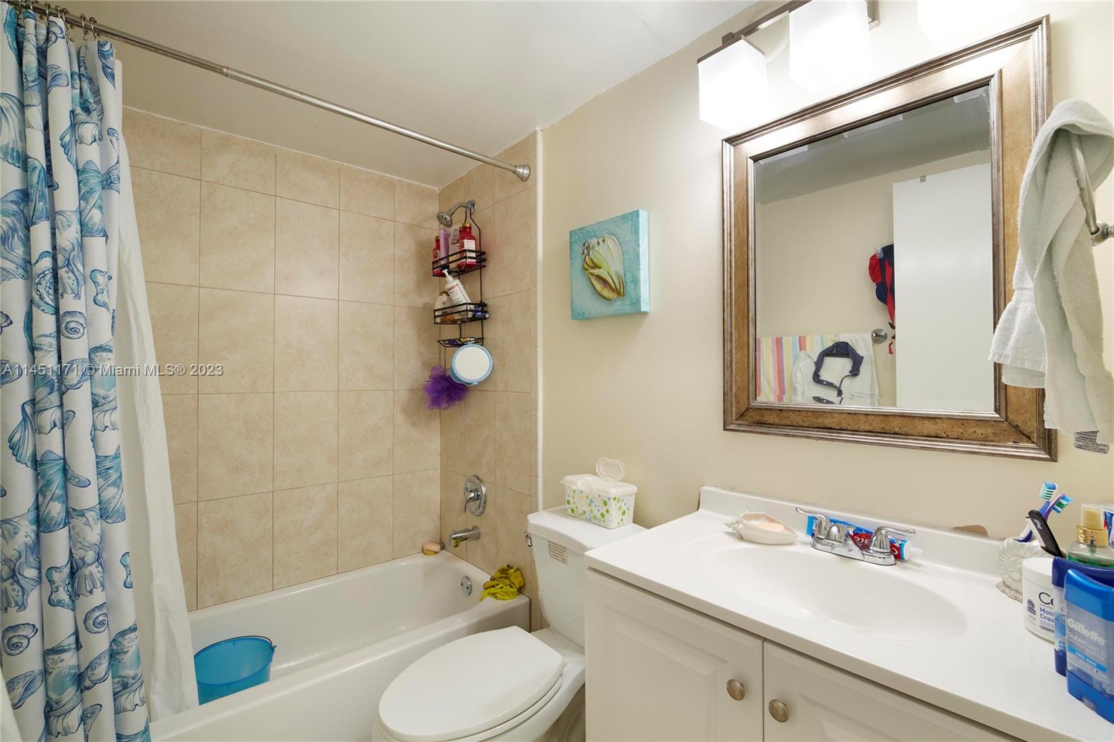 6705 Northwest 169th Street, Unit C205 Hialeah, FL 33015 - Photo 7 of 13 a bathroom with a sink toilet and shower