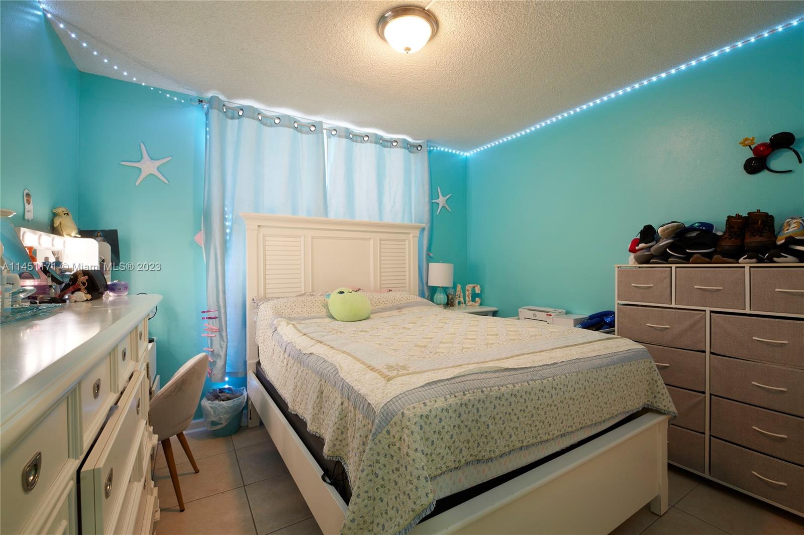 6705 Northwest 169th Street, Unit C205 Hialeah, FL 33015 - Photo 8 of 13 a bedroom with a bed and a window