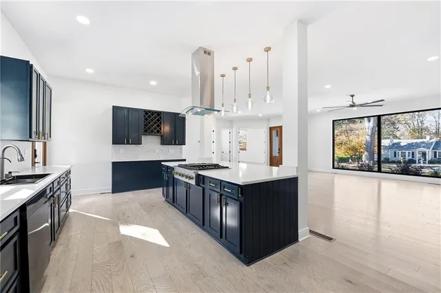 a kitchen with stainless steel appliances wooden cabinets and granite counter tops
