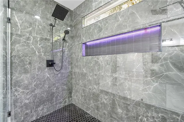 a bathroom with a bathtub shower sink vanity and toilet