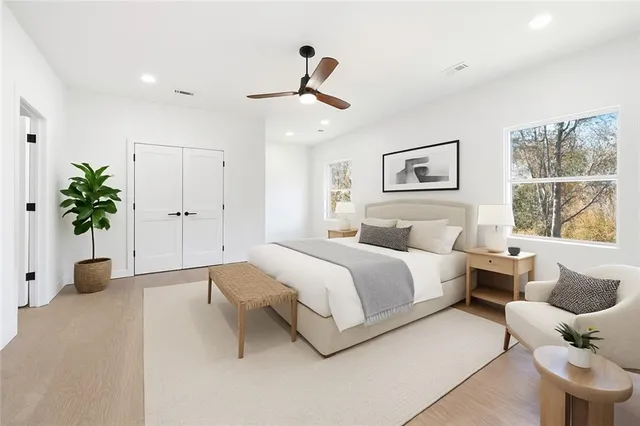 a bathroom with a double vanity sink a mirror and a bathtub