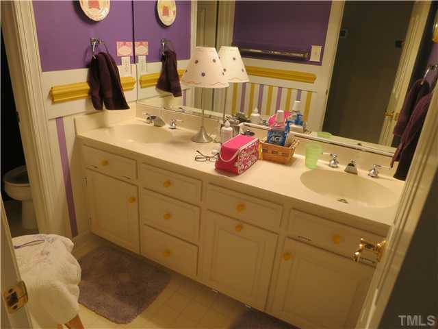 3516 Banks Road Raleigh, NC 27603 - Photo 20 of 24 a bathroom with a sink mirror and vanity