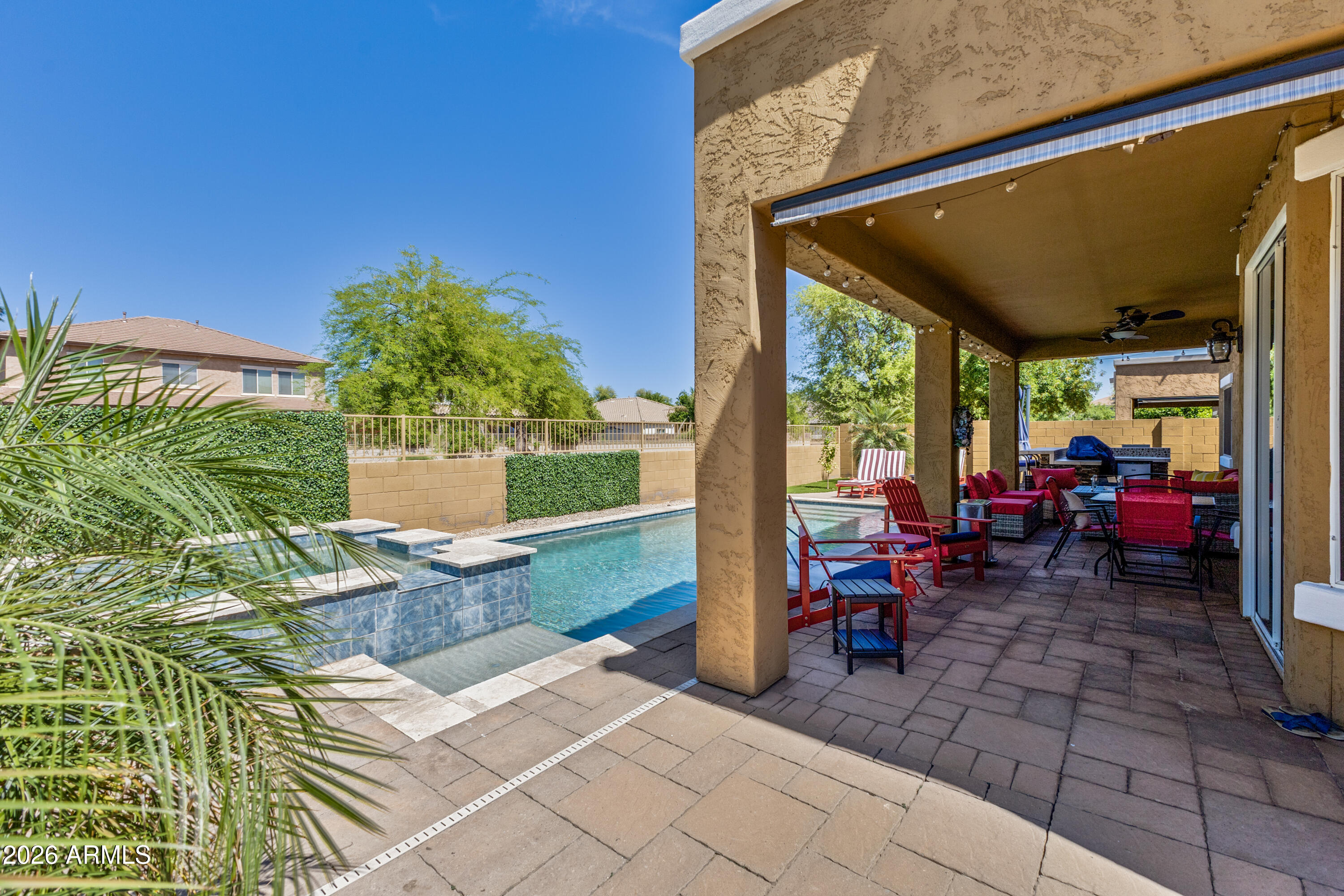 3256 East Geronimo Court Gilbert, AZ 85295 - Photo 11 of 53 a view of a patio with table and chairs potted plants with wooden floor and fence