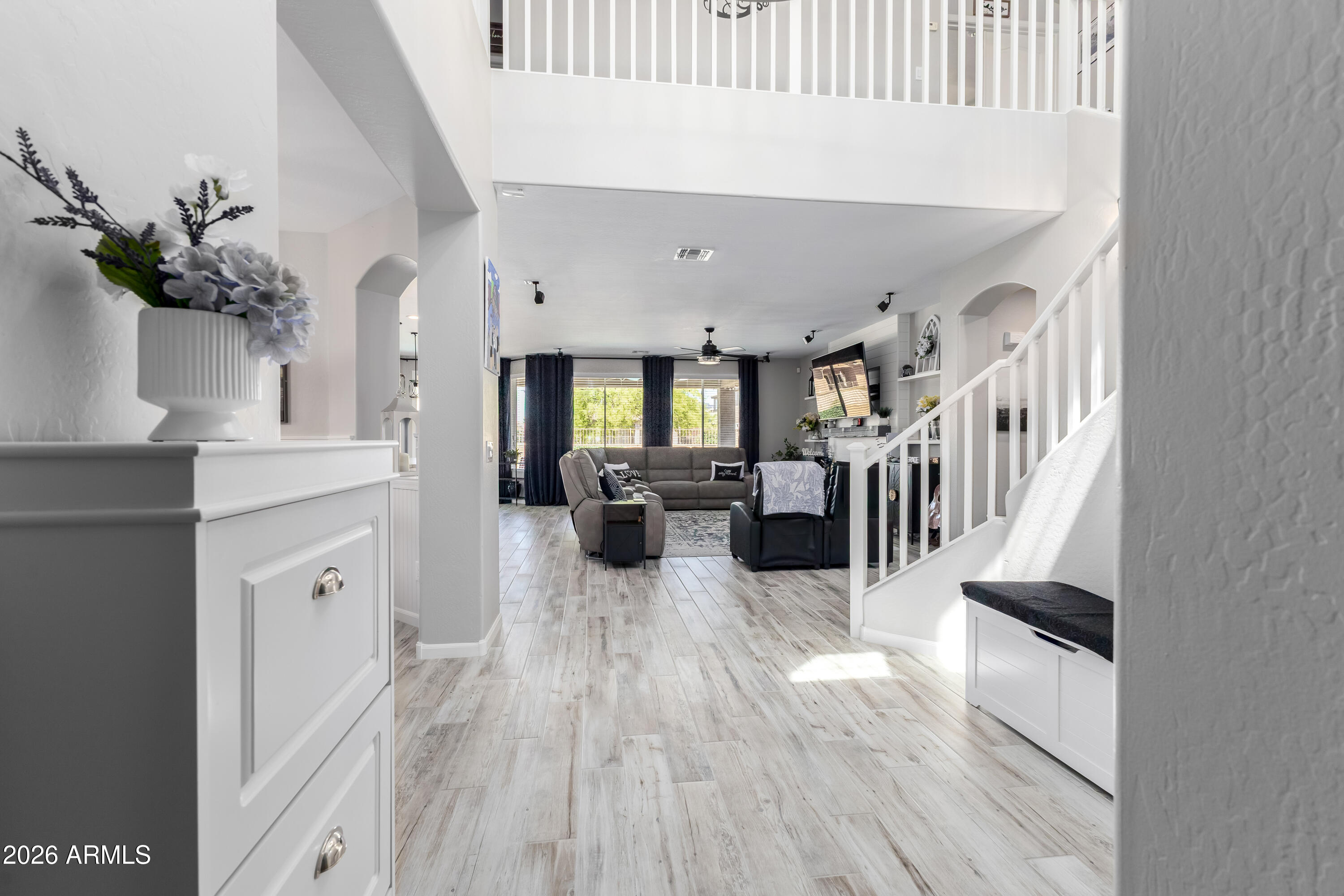 3256 East Geronimo Court Gilbert, AZ 85295 - Photo 16 of 53 a view of living room kitchen and entryway with wooden floor