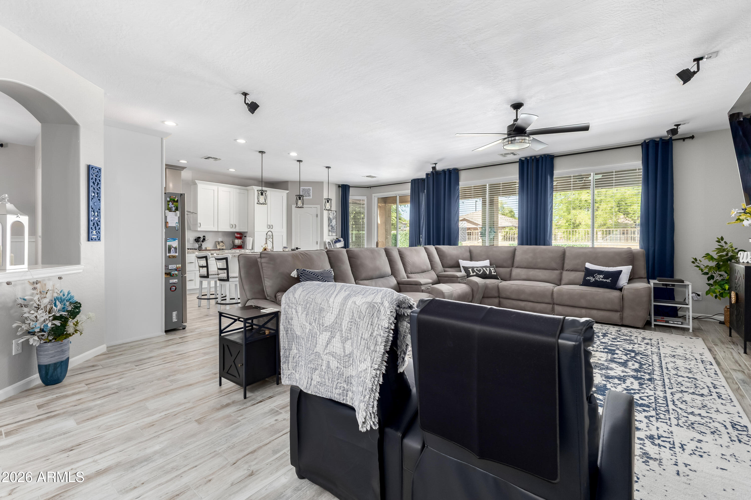 3256 East Geronimo Court Gilbert, AZ 85295 - Photo 22 of 53 a living room with furniture a window and a chandelier