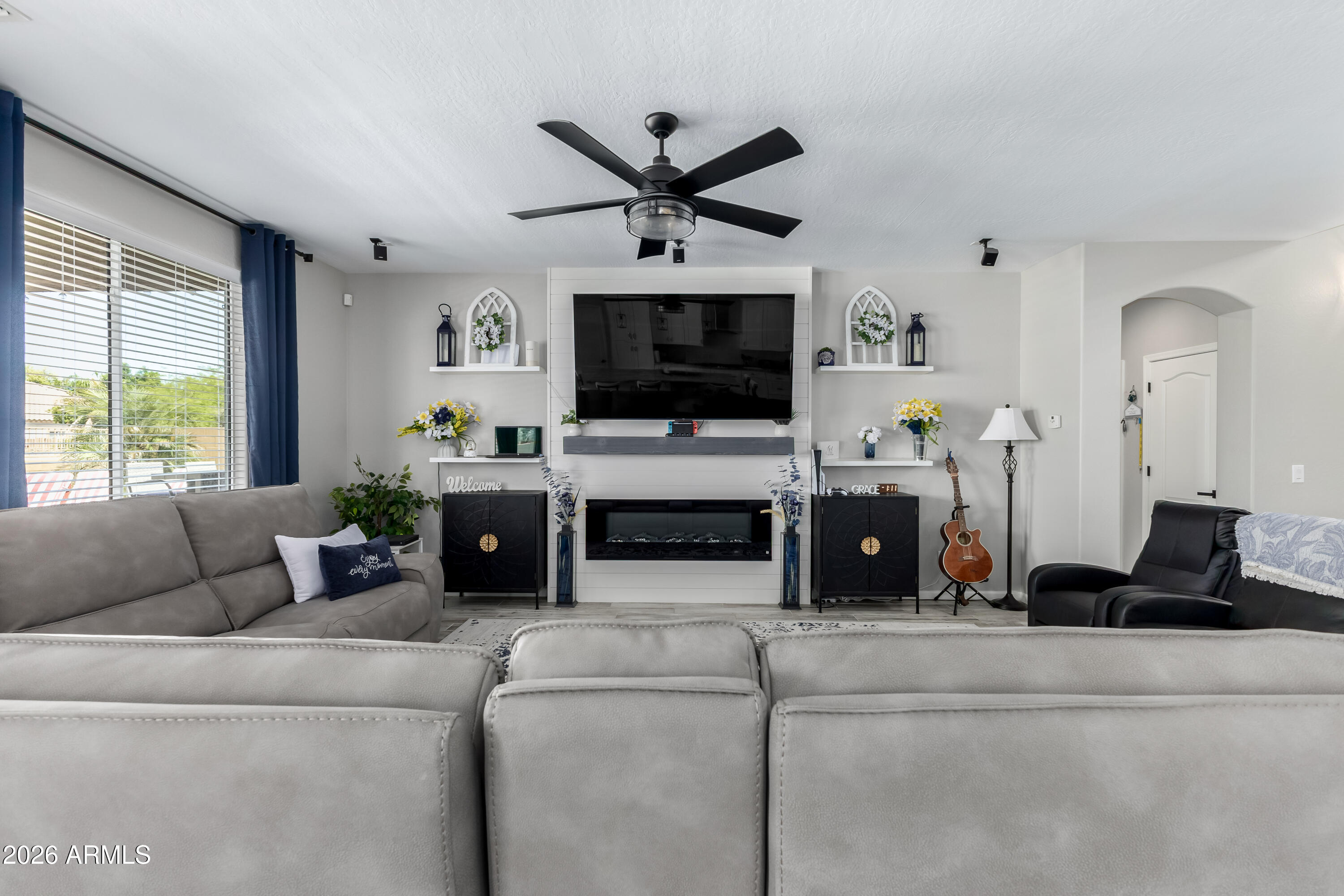 3256 East Geronimo Court Gilbert, AZ 85295 - Photo 24 of 53 a living room with furniture a flat screen tv and a window