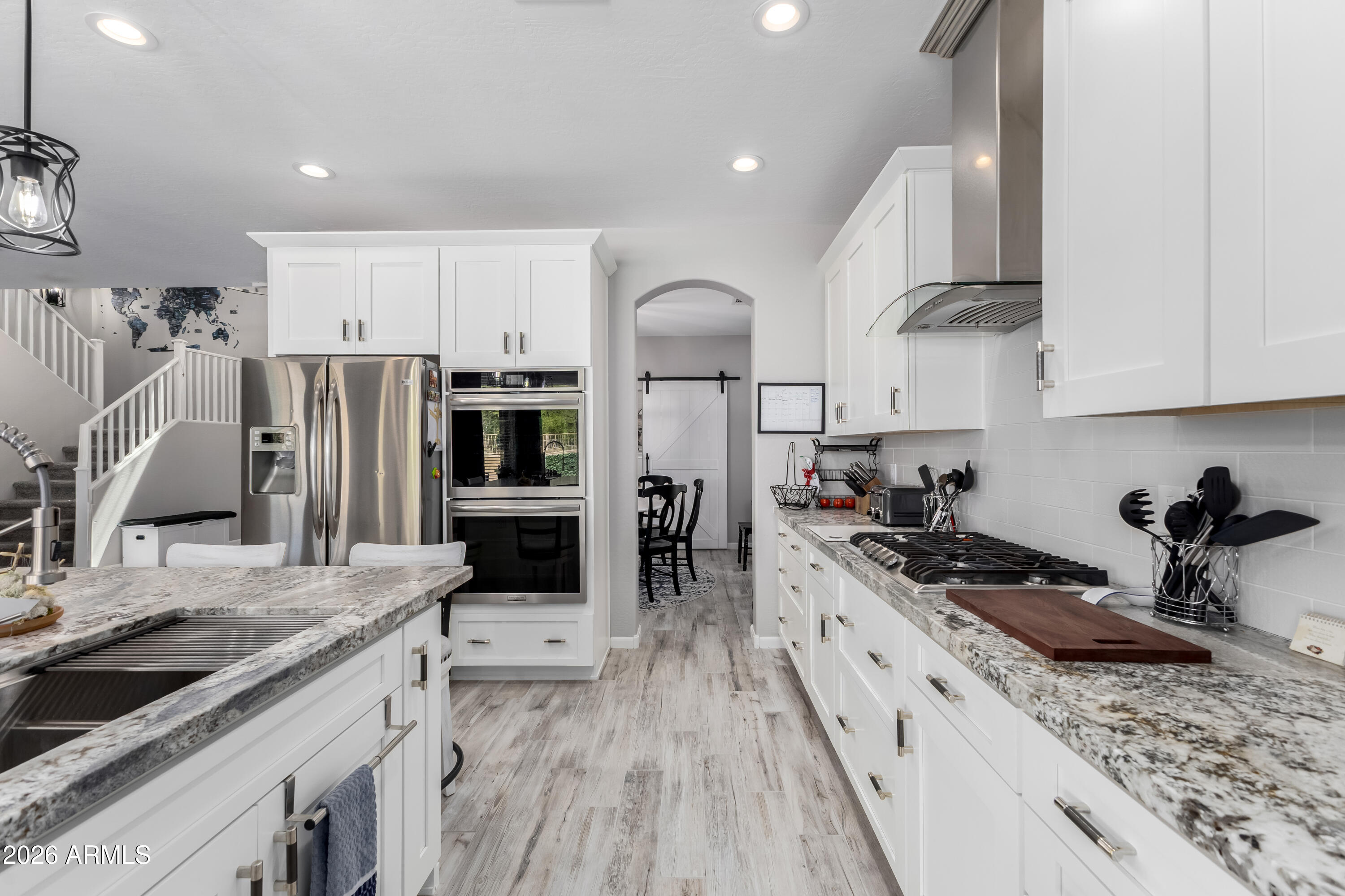 3256 East Geronimo Court Gilbert, AZ 85295 - Photo 30 of 53 a kitchen with stainless steel appliances granite countertop a sink stove and refrigerator