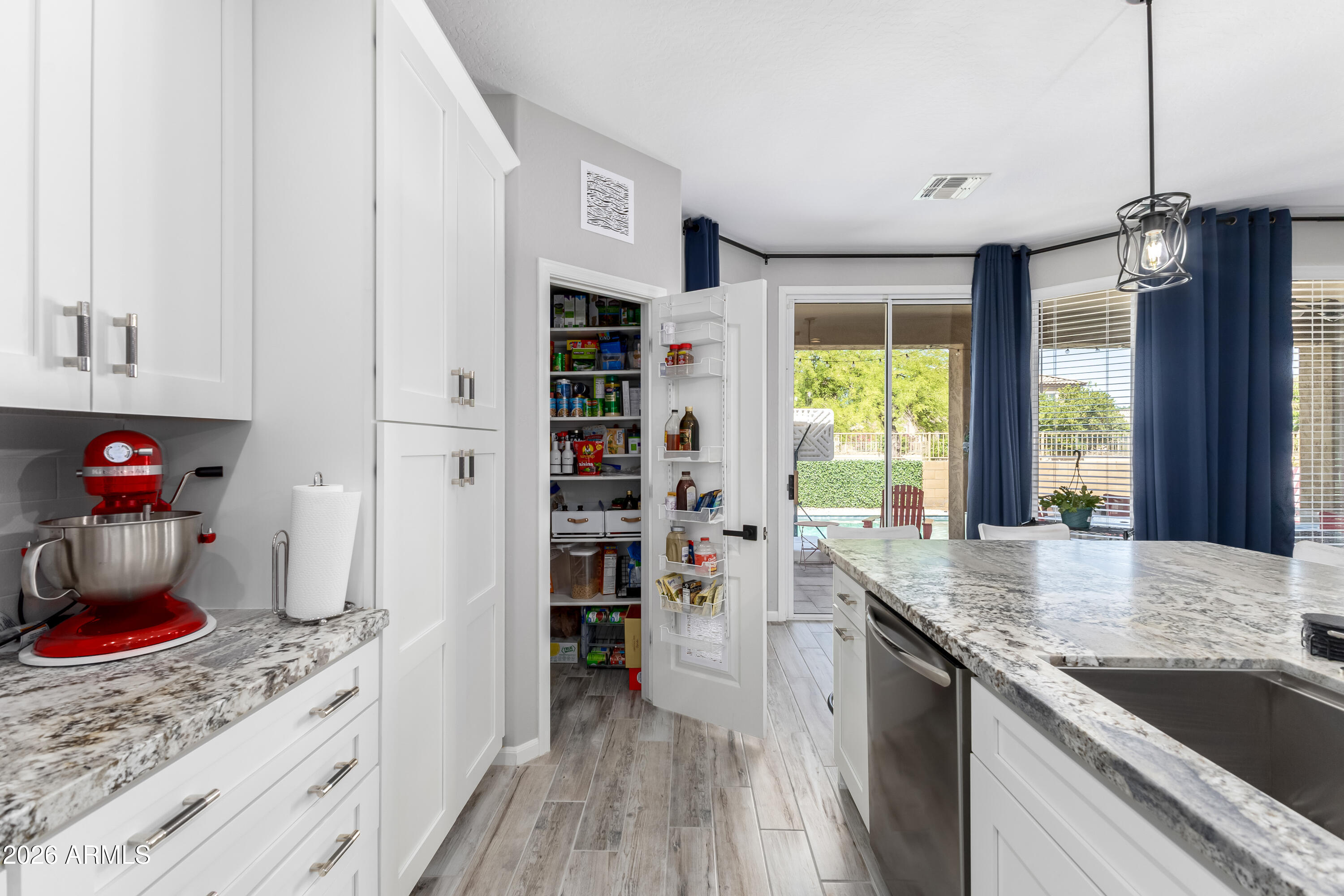 3256 East Geronimo Court Gilbert, AZ 85295 - Photo 31 of 53 a kitchen with stainless steel appliances granite countertop a sink stove and cabinets