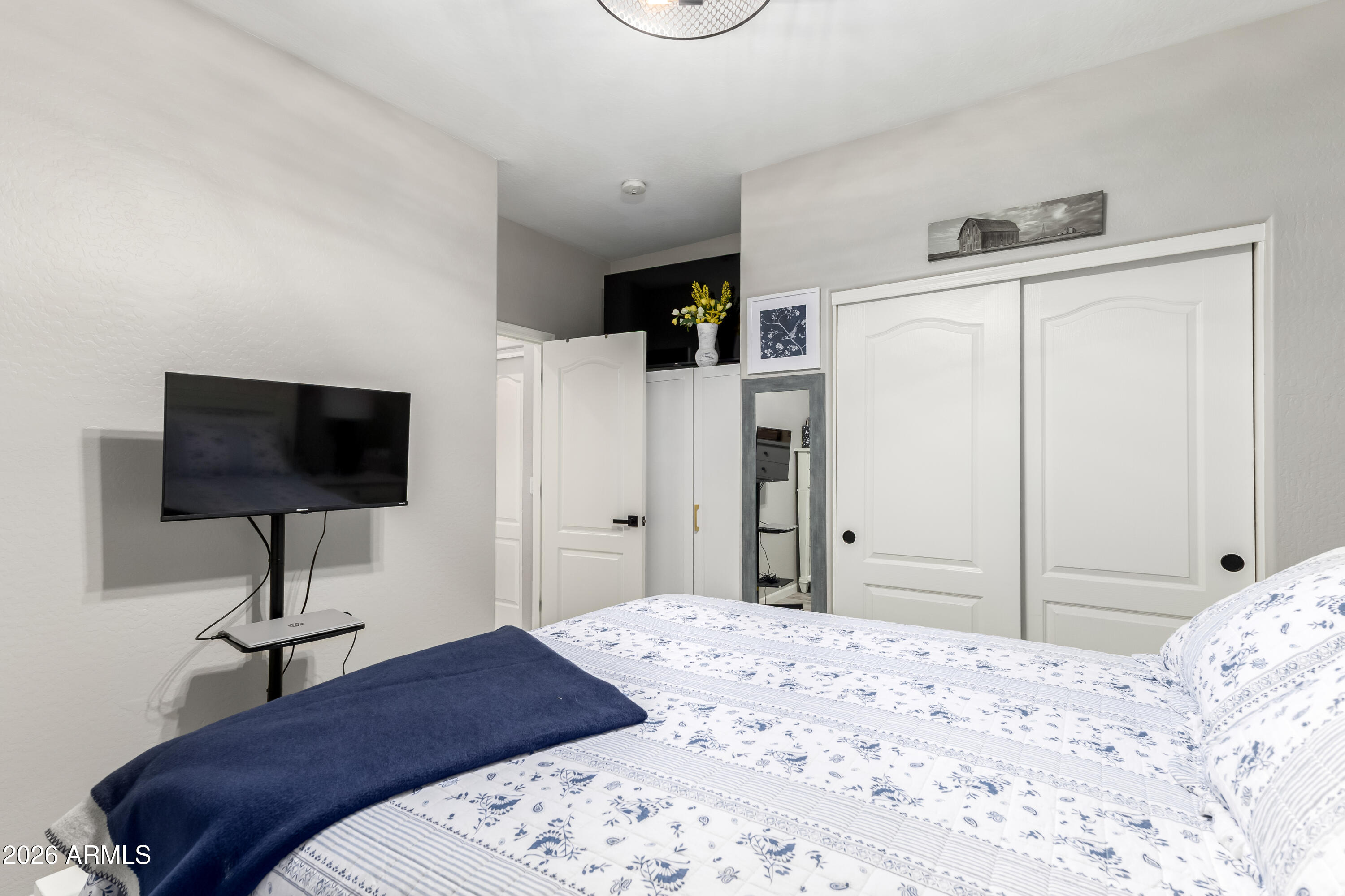 3256 East Geronimo Court Gilbert, AZ 85295 - Photo 36 of 53 a bedroom with a bed and a flat screen tv