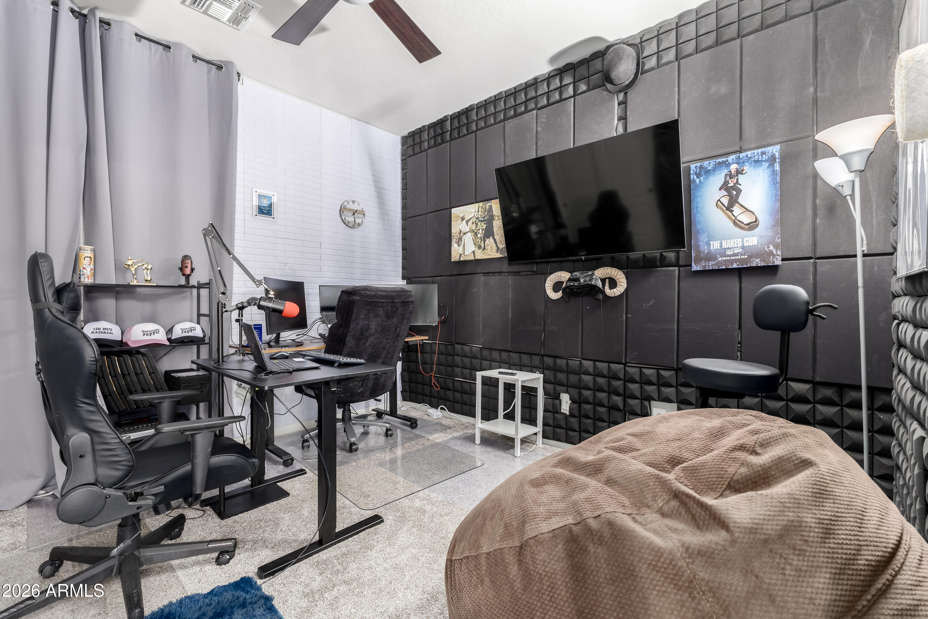 3256 East Geronimo Court Gilbert, AZ 85295 - Photo 38 of 53 a bedroom with a bed a flat screen tv and chairs