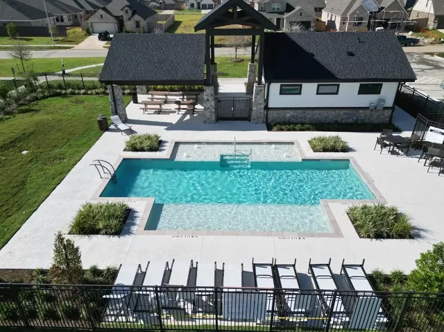 a view of a swimming pool with a patio