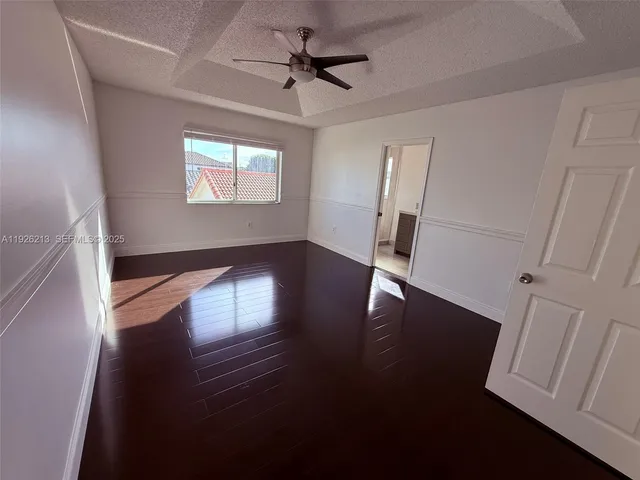 a view of a room with wooden floor and windows