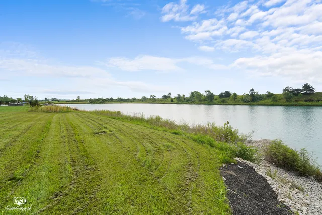 a view of a large building with yard in front of it