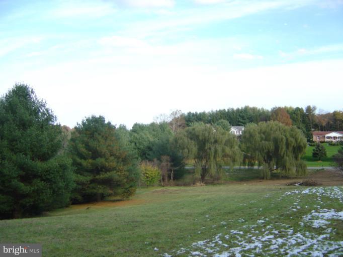 18002 Marshall Mill Road Hampstead, MD 21074 - Photo 27 of 30 a view of a grassy field with trees
