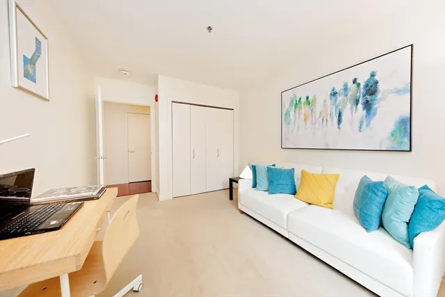 a living room with furniture and wall paintings