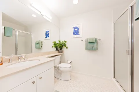 a bathroom with a toilet sink and mirror