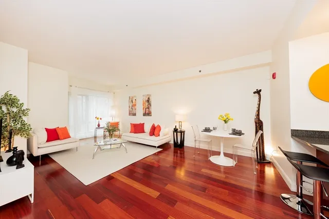 a living room with furniture and wooden floor
