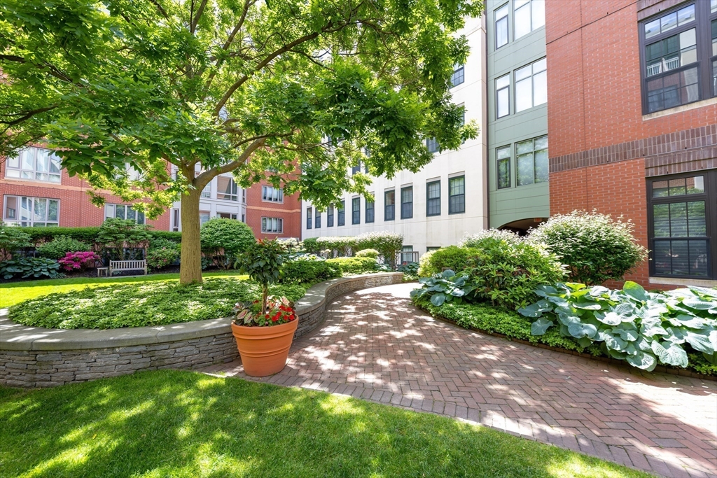 20 Second Street, Unit 222 Cambridge, MA 02141 - Photo 24 of 38 a front view of a house with a yard and outdoor seating