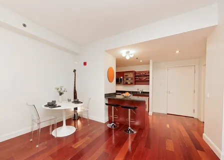 a view of a workspace with furniture and wooden floor