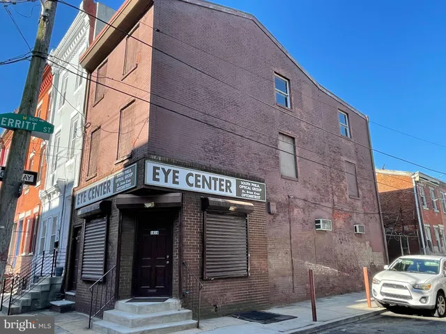a front view of a building with parking