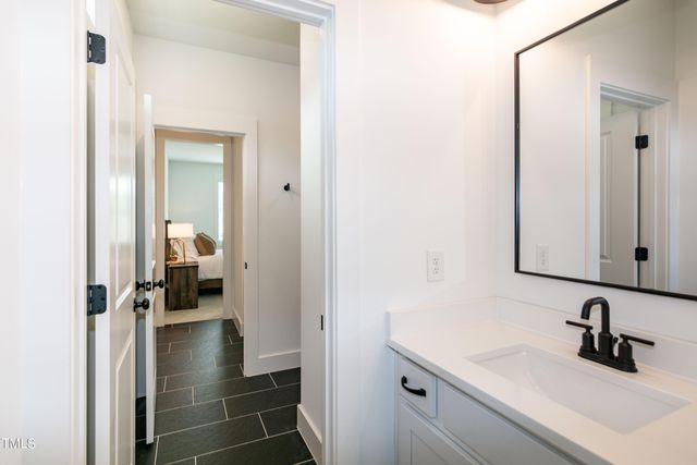 a view of a hallway with wooden floor and a living room