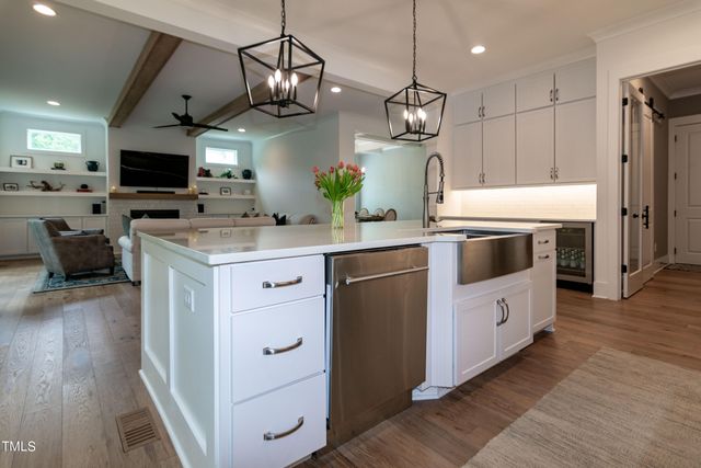 a bathroom with a white tub shower vanity and a sink