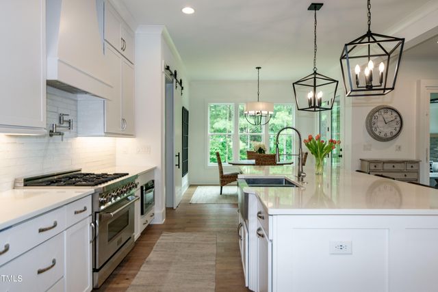 a view of a dining room with furniture wooden floor and chandelier