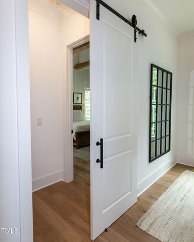 a spacious bedroom with a bed and a chandelier