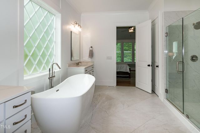 a bedroom with a large bed and a dresser