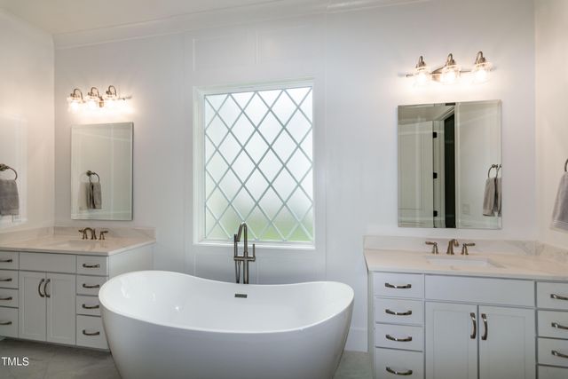 a living room with furniture a fireplace and a floor to ceiling window