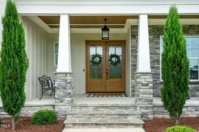 a view of a hallway with wooden floor and stairs