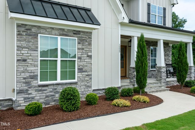 a view of a hallway with a livingroom and entryway