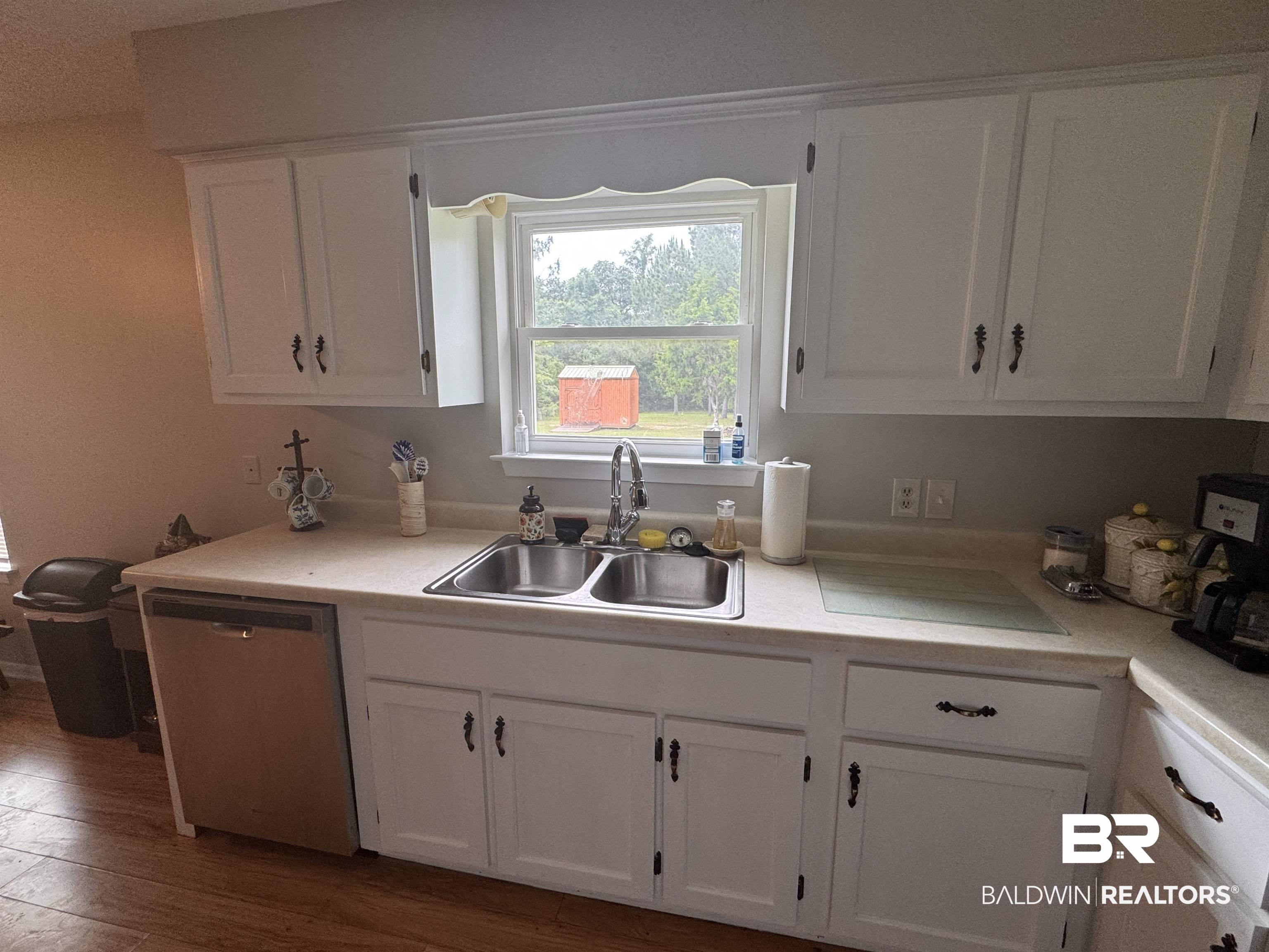 15148 Highland Circle Foley, AL 36535 - Photo 17 of 47 Kitchen with dishwasher, a sink, white cabinets, and light countertops
