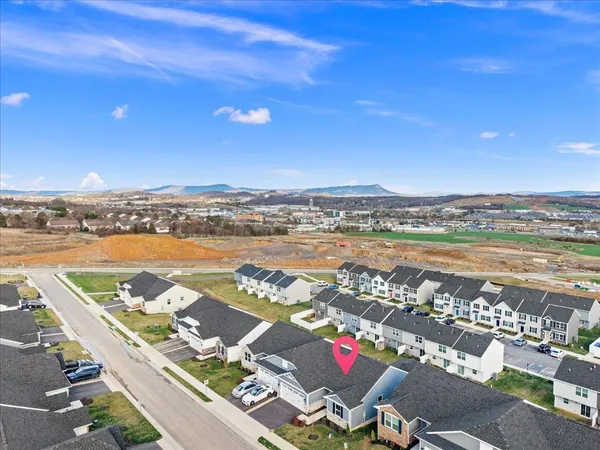 an aerial view of residential building with outdoor space and ocean view