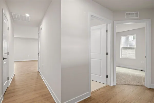 a view of a hallway with wooden floor
