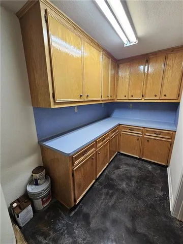 a view of a big yard with table and chairs under an umbrella