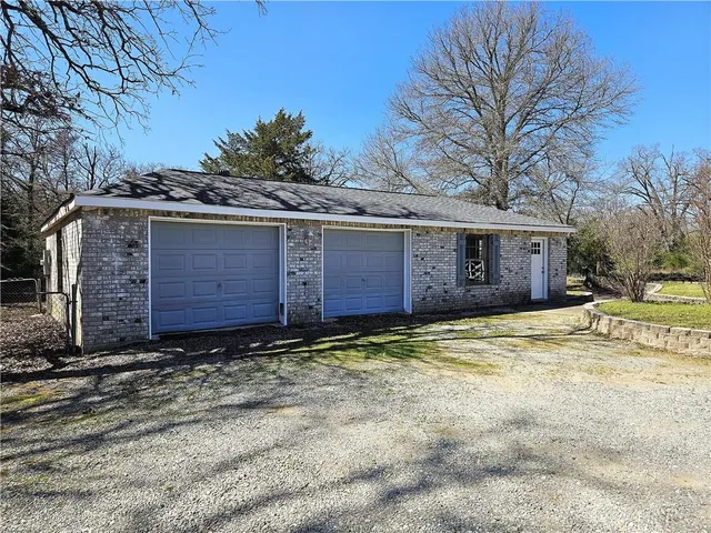 a large tree in front of a house
